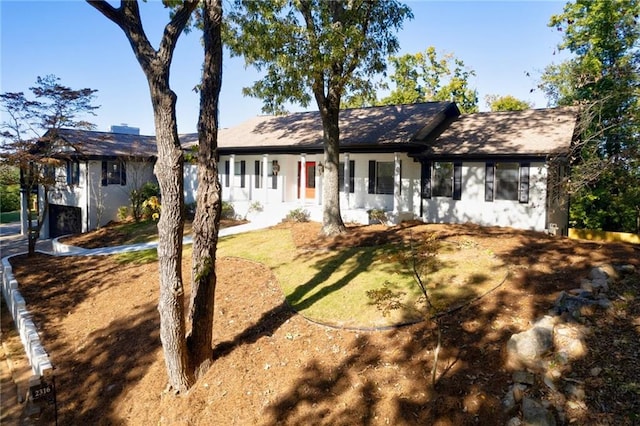 ranch-style house with a front lawn