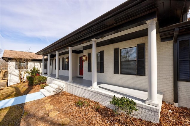 view of home's exterior featuring a porch and brick siding