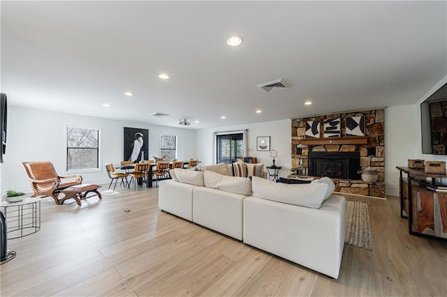 2316 Mountain Crest Pl, Gainesville, GA 30501 - living room with healthy amount of natural light, light wood-style flooring, a stone fireplace, recessed lighting, and baseboards