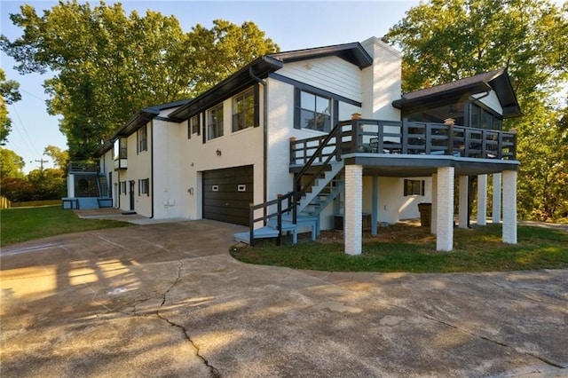 2316 Mountain Crest Pl, Gainesville, GA 30501 - view of front facade with an attached garage, driveway, a wooden deck, and stairway