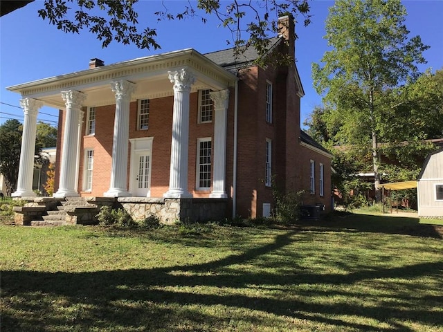 greek revival inspired property with a front yard