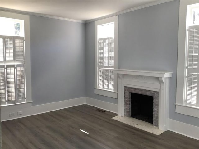 unfurnished living room featuring ornamental molding, dark wood-type flooring, and a fireplace