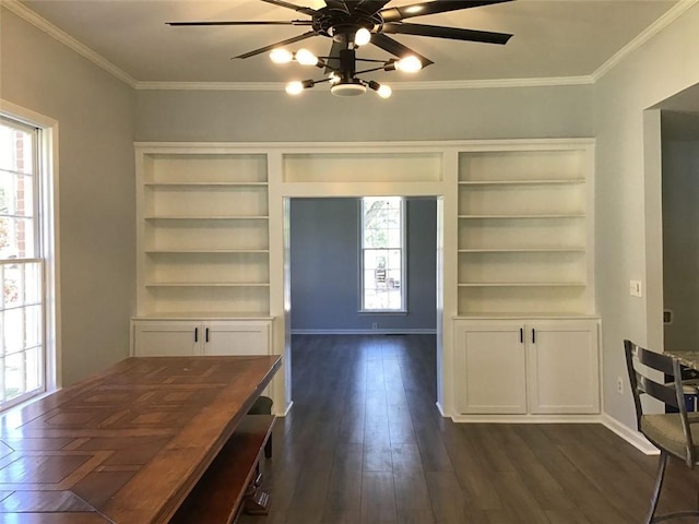 unfurnished dining area featuring dark wood-type flooring, crown molding, and ceiling fan