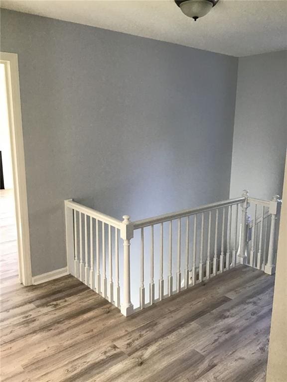 staircase with hardwood / wood-style flooring