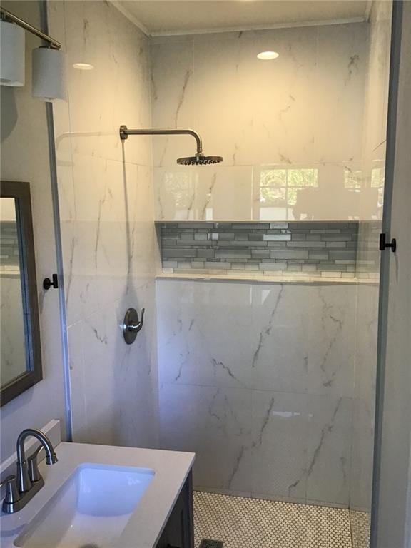 bathroom with vanity and tiled shower