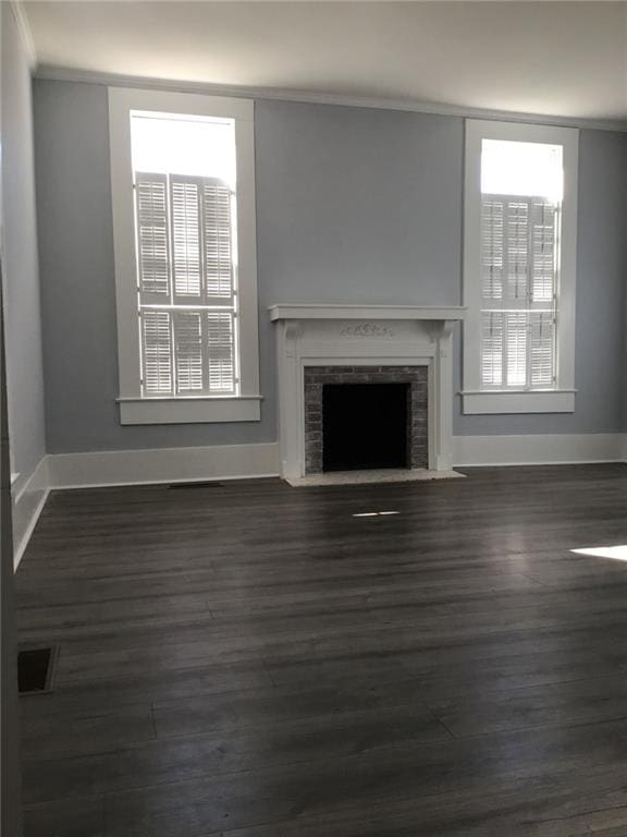 unfurnished living room with dark wood-type flooring and a fireplace