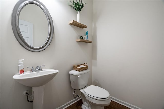 1628 Newport Dr, Bethlehem, GA 30620 - bathroom with baseboards, toilet, and wood finished floors