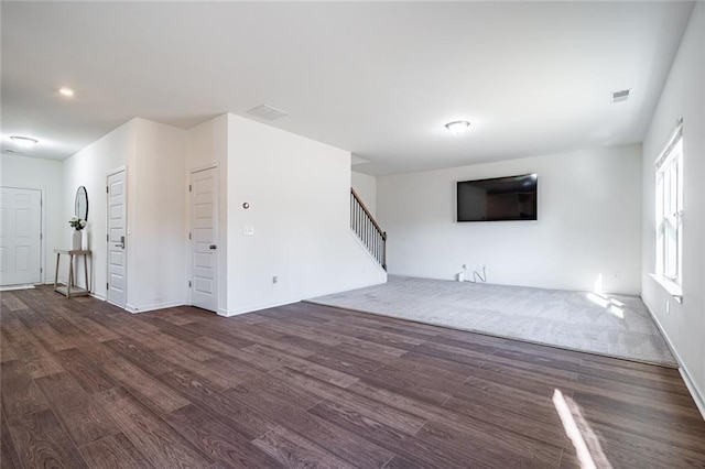 1628 Newport Dr, Bethlehem, GA 30620 - unfurnished living room with stairs, wood finished floors, and baseboards