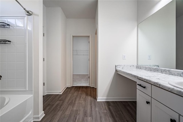 1628 Newport Dr, Bethlehem, GA 30620 - bathroom with wood finished floors, vanity, baseboards, and a walk in closet