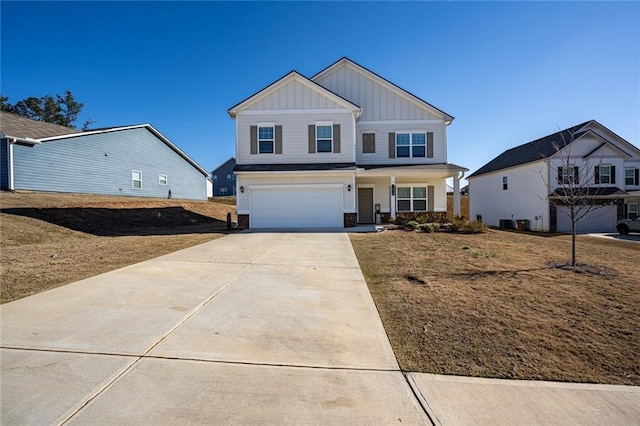 1628 Newport Dr, Bethlehem, GA 30620 - view of front of home featuring board and batten siding, a garage, driveway, and covered porch