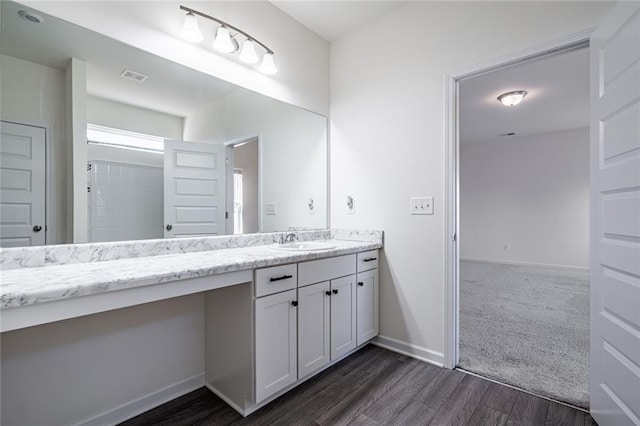 1628 Newport Dr, Bethlehem, GA 30620 - bathroom featuring vanity, wood finished floors, and baseboards