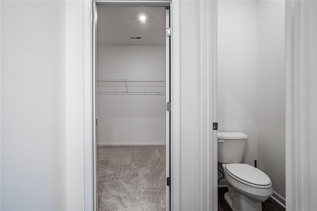 1628 Newport Dr, Bethlehem, GA 30620 - bathroom featuring toilet, a spacious closet, and baseboards