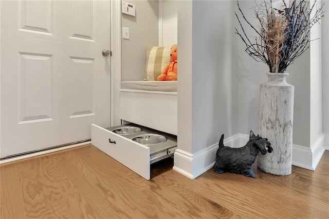 mudroom with baseboards and wood finished floors