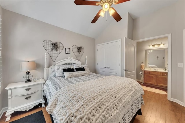 bedroom featuring baseboards, lofted ceiling, ceiling fan, wood finished floors, and a closet