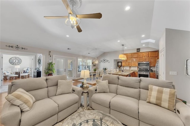 living area featuring lofted ceiling, recessed lighting, ceiling fan, and french doors