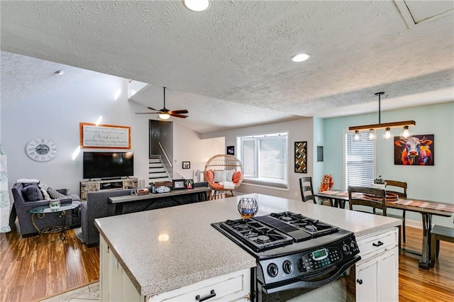 1189 Norfolk Dr NW, Acworth, GA 30102 - kitchen with white cabinetry, black range with gas cooktop, a textured ceiling, and light countertops