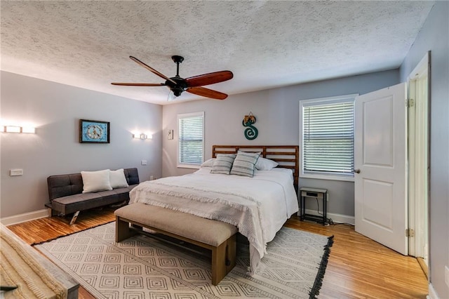 1189 Norfolk Dr NW, Acworth, GA 30102 - bedroom with a textured ceiling, baseboards, light wood finished floors, and multiple windows