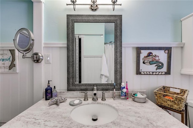 1189 Norfolk Dr NW, Acworth, GA 30102 - full bathroom with a decorative wall, vanity, a wainscoted wall, and curtained shower