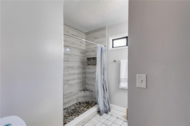 1189 Norfolk Dr NW, Acworth, GA 30102 - full bath with a textured ceiling, toilet, baseboards, and tiled shower