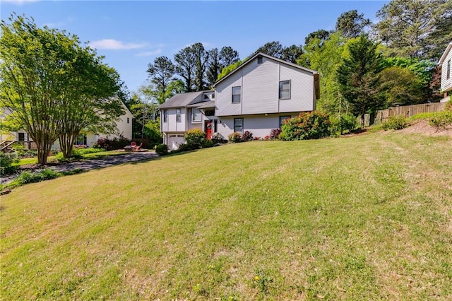 1189 Norfolk Dr NW, Acworth, GA 30102 - rear view of house with fence, a yard, and an attached garage