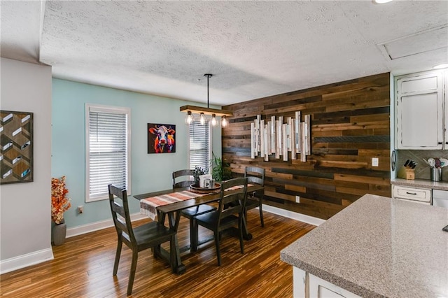 1189 Norfolk Dr NW, Acworth, GA 30102 - dining area featuring wooden walls, a textured ceiling, dark wood-style flooring, and baseboards