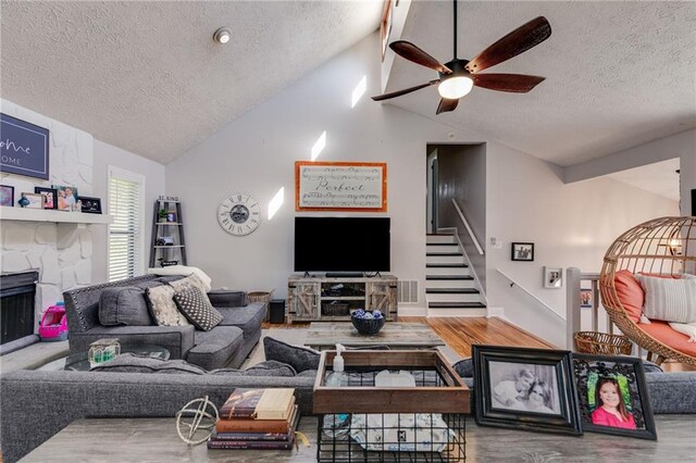 1189 Norfolk Dr NW, Acworth, GA 30102 - living room with lofted ceiling, a textured ceiling, stairway, wood finished floors, and a ceiling fan
