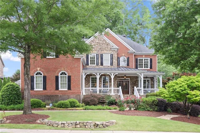 2630 Weddington Pl NE, Marietta, GA 30068 - view of front of home featuring stone siding, a porch, a front lawn, and brick siding