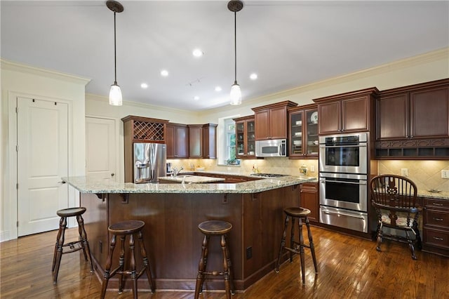 2630 Weddington Pl NE, Marietta, GA 30068 - kitchen with appliances with stainless steel finishes, a warming drawer, decorative backsplash, crown molding, and dark wood-style flooring