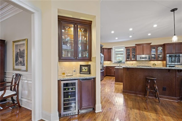 2630 Weddington Pl NE, Marietta, GA 30068 - indoor dry bar with wine cooler, stainless steel microwave, tasteful backsplash, dark wood-style floors, and ornamental molding