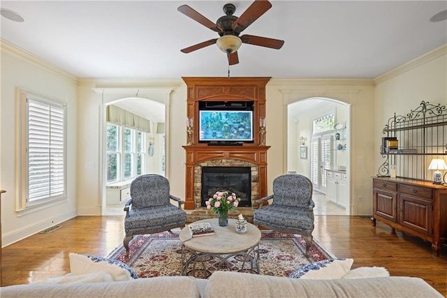 2630 Weddington Pl NE, Marietta, GA 30068 - living area featuring a ceiling fan, crown molding, arched walkways, wood finished floors, and a large fireplace