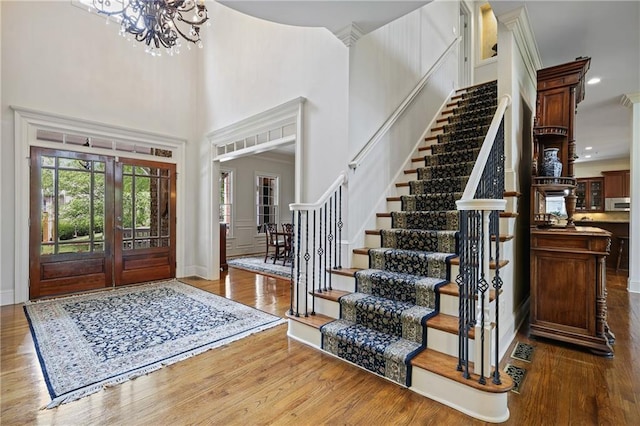 2630 Weddington Pl NE, Marietta, GA 30068 - entryway featuring wood finished floors, stairway, a chandelier, a towering ceiling, and baseboards