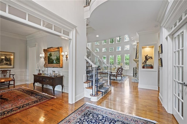 2630 Weddington Pl NE, Marietta, GA 30068 - entryway with wood finished floors, a decorative wall, decorative columns, ornamental molding, and stairs