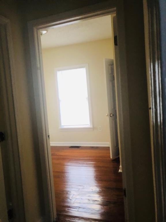 hall with dark hardwood / wood-style flooring