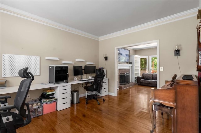 1019 Legacy Walk, Woodstock, GA 30189 - office area featuring wood finished floors, a brick fireplace, crown molding, and baseboards