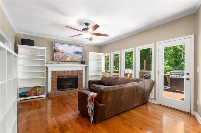 1019 Legacy Walk, Woodstock, GA 30189 - living area featuring hardwood / wood-style floors, a ceiling fan, a brick fireplace, and ornamental molding
