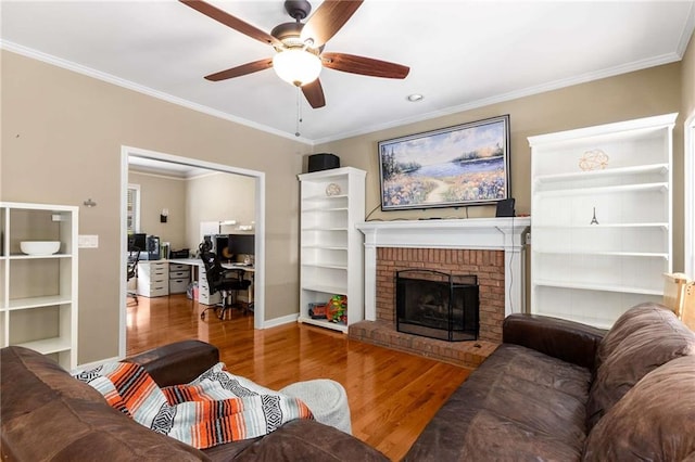 1019 Legacy Walk, Woodstock, GA 30189 - living area with wood finished floors, a desk, a ceiling fan, ornamental molding, and a brick fireplace