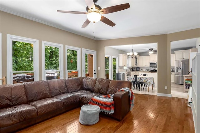 1019 Legacy Walk, Woodstock, GA 30189 - living area with a chandelier, a ceiling fan, hardwood / wood-style flooring, and crown molding