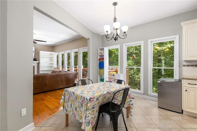 1019 Legacy Walk, Woodstock, GA 30189 - dining space featuring a chandelier, light tile patterned floors, and a ceiling fan