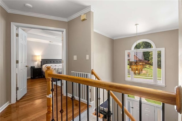 1019 Legacy Walk, Woodstock, GA 30189 - hallway featuring an upstairs landing, wood finished floors, crown molding, and baseboards