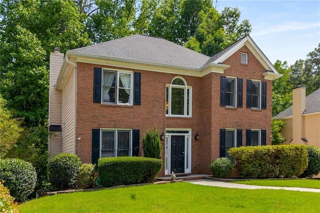 1019 Legacy Walk, Woodstock, GA 30189 - view of front facade with a front lawn, a chimney, and brick siding
