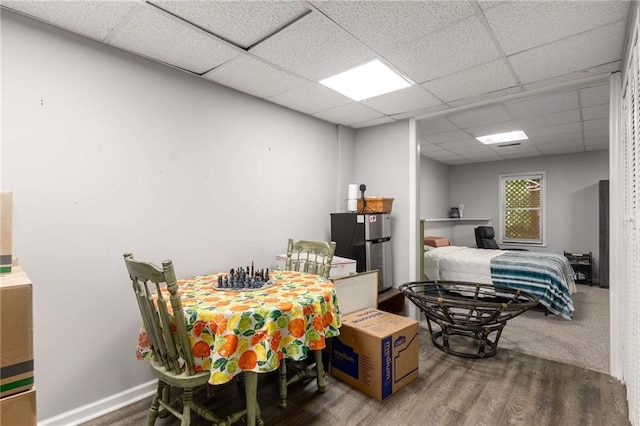 1019 Legacy Walk, Woodstock, GA 30189 - bedroom featuring a paneled ceiling, wood finished floors, freestanding refrigerator, and baseboards