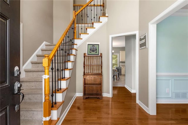 1019 Legacy Walk, Woodstock, GA 30189 - entryway featuring wood finished floors, a high ceiling, stairs, and baseboards