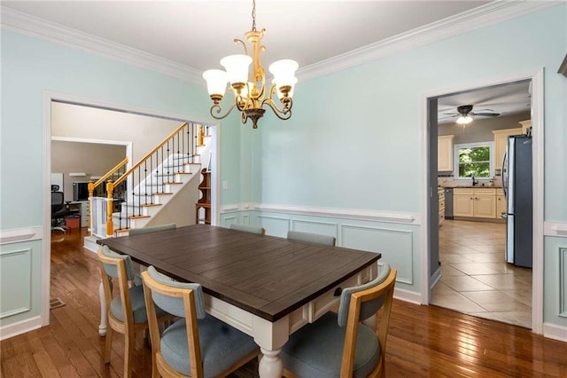 1019 Legacy Walk, Woodstock, GA 30189 - dining area with stairway, hardwood / wood-style flooring, crown molding, a chandelier, and a wainscoted wall