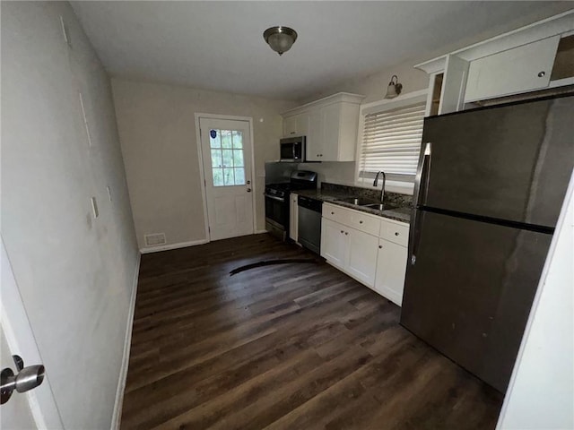 kitchen with white cabinets, dark hardwood / wood-style flooring, sink, and appliances with stainless steel finishes