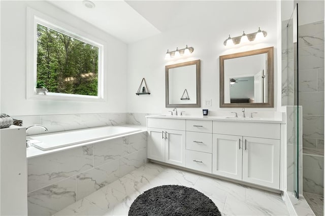 full bathroom featuring marble look tiles, a garden tub, double vanity, ceiling fan, and a marble finish shower