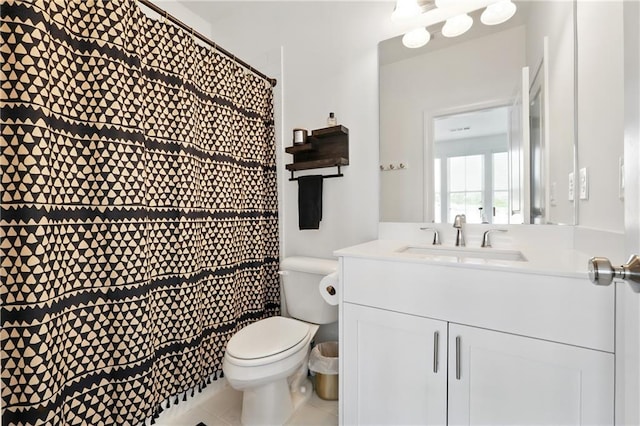 bathroom featuring toilet, vanity, a shower with curtain, and tile patterned floors