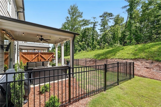 view of yard with ceiling fan and outdoor lounge area