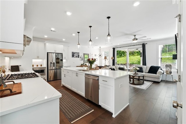 kitchen with stainless steel appliances, open floor plan, a ceiling fan, recessed lighting, and white cabinets