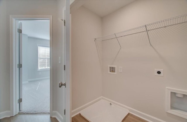 laundry area with hookup for a washing machine, hardwood / wood-style flooring, hookup for an electric dryer, and hookup for a gas dryer