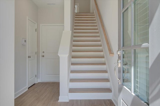 stairs with hardwood / wood-style floors